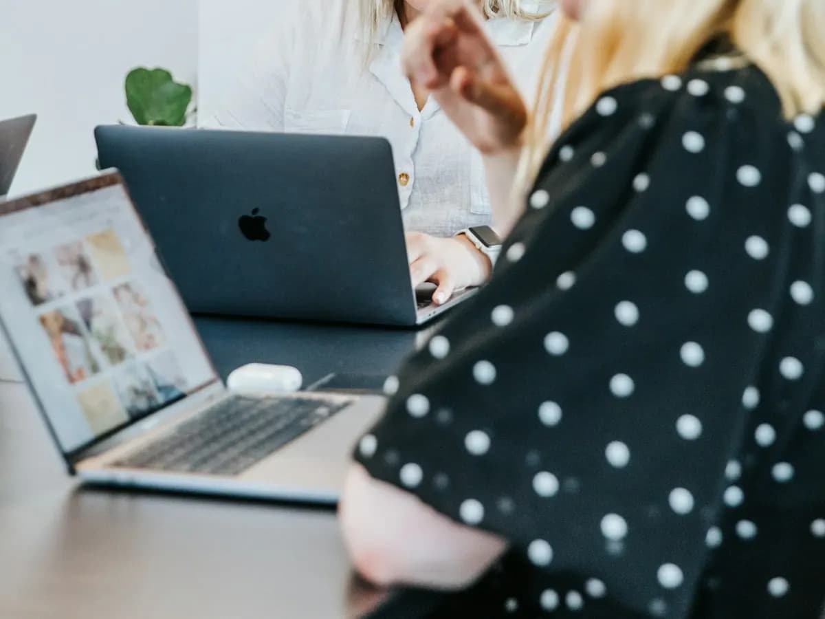 Deux collègues échangeant devant un ordinateur portable